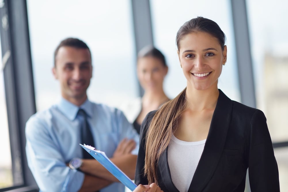 Group of happy young business people in a meeting at office